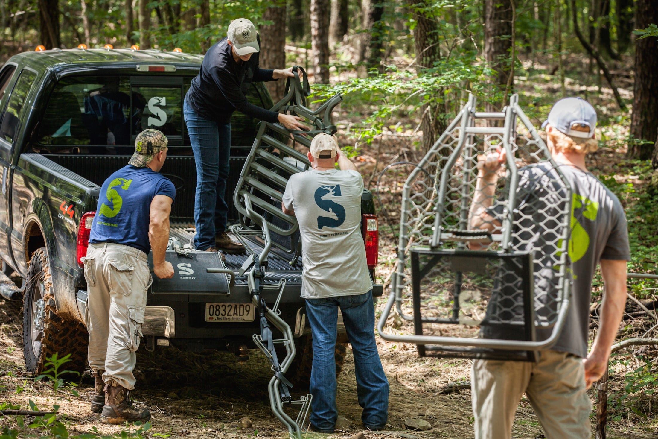 Men Working to Unload and Hang Up Tree Stands 