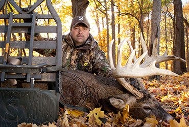 Man and Harvested Whitetail Deer