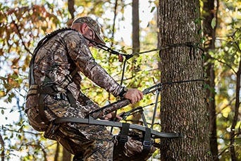 Hunter Using Climbing Stand 