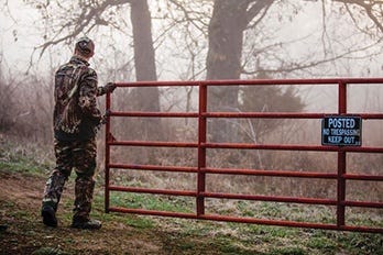 Man Closing Gate to Private Land 