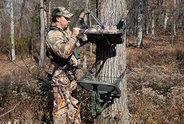 Man Setting Up Tree Stand