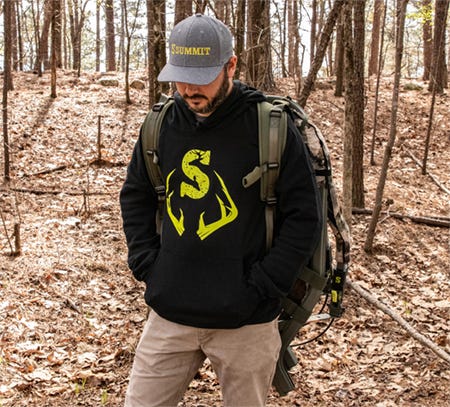 Man in woods wearing a black Summit Treestands hoodie and cap