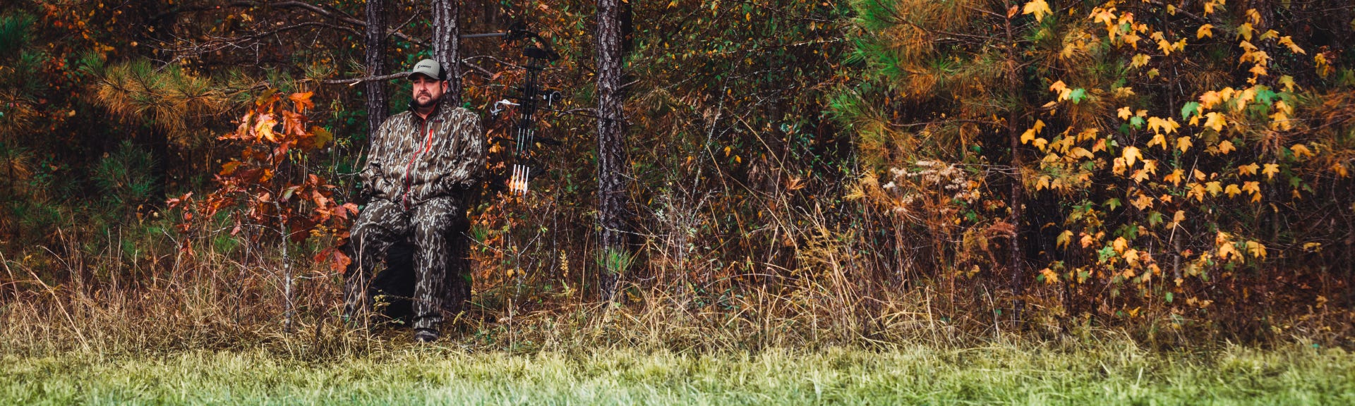 Man sitting in woods in the new Summit Captain's Chair Portable Tree Seat