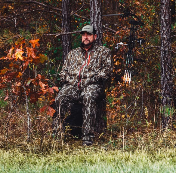 Man sitting in woods in the new Summit Captain's Chair Portable Tree Seat